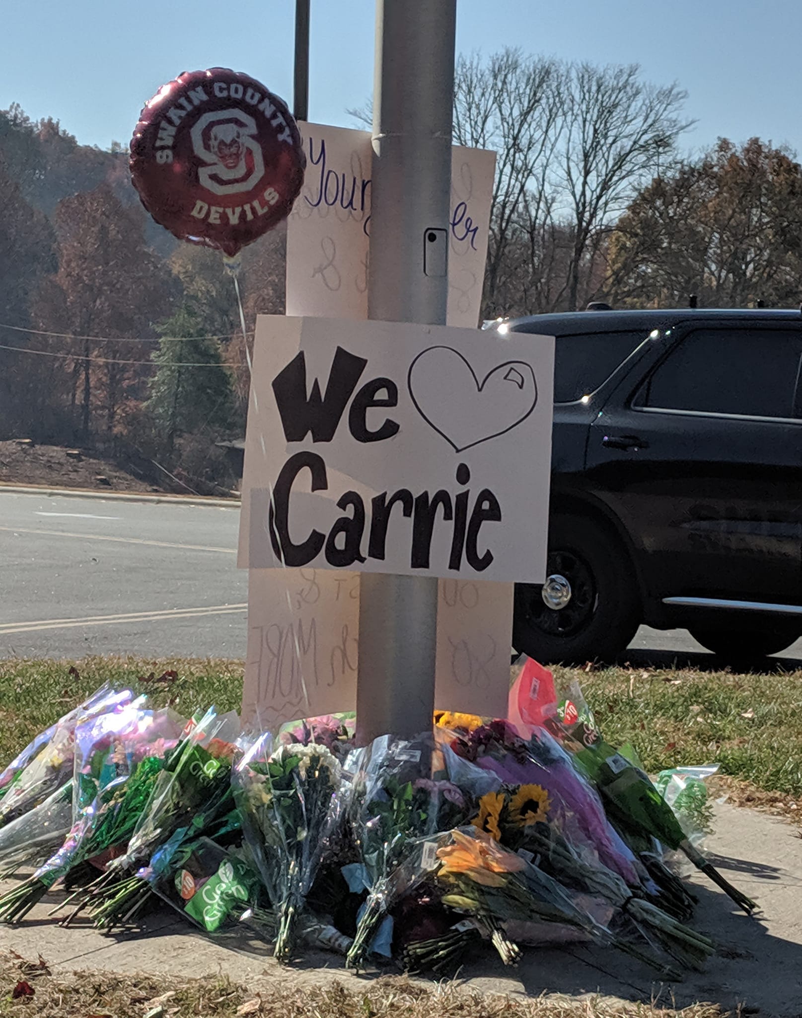 Swain High School had a ceremony on Tuesday in front of the school on Tuesday. At left, posters, balloons and flowers were left in memory of the beloved athletic trainer who made a positive impact on so many lives.