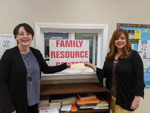 Karen Proctor of the Swain County Chamber of Commerce presents Family Resource Center Director Melissa Barker with a check for $150 for food purchases.