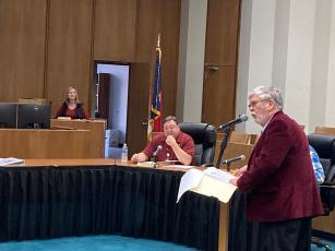 Rep. Mike Clampitt speaks before Swain County commissioners on Tuesday. Commissioner Phillip Carson looks on. 