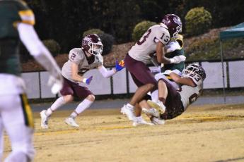 From left, Maroon Devils Corey Stilwell, Josiah Glaspie and Skeet Cook step up the defense in the win over Bessemer City Friday night.