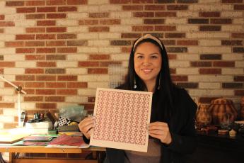 Cherokee artist Skye Tafoya specializes in patterned paper weaving art, which she sells to make a living.