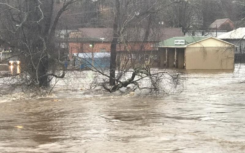 The Tuckasegee River overflowed its banks on Thursday following 3-4 inches of rain. Pictured above, the river reaches beyond Island Street and up by Grumpy's Car Wash in downtown Bryson City. 