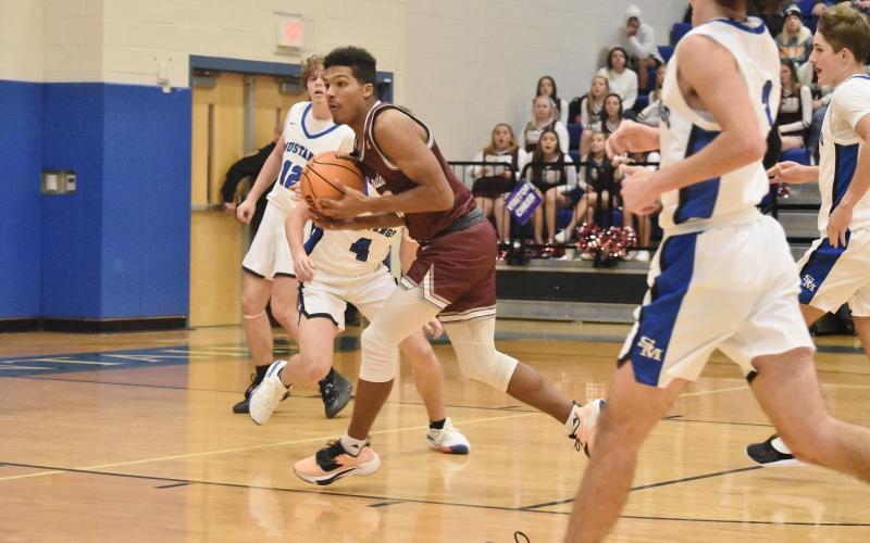 Maroon Devil Josiah Glaspie catches the pass and goes toward the basket at the away game vs. Smoky Mountain. Photo by Joanna McMahan/Swain Schools