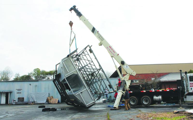At Smoky Mountain Boatworks in Bryson City on Thursday, March 23, a Catamaran boat was flipped over by a crane, with inspectors intending to come by this week to make sure it’s ready for sailing in Albemarle Sound for passenger trips.
