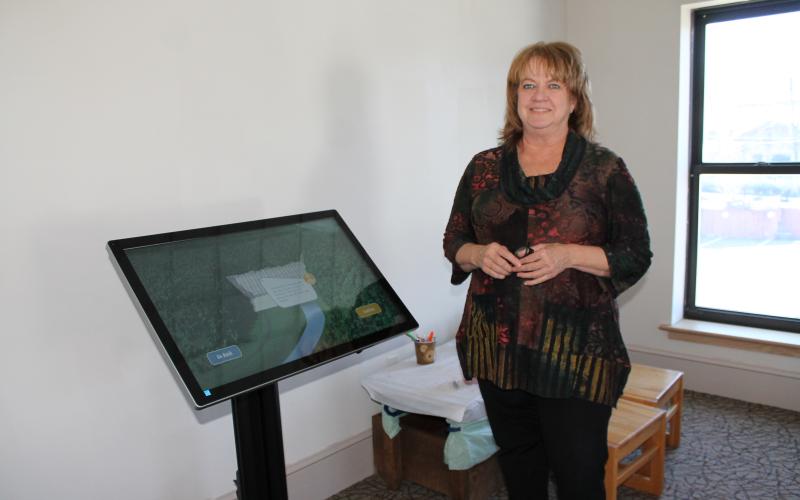 Mary Ann Shea shows off the new Story of Fontana Dam interactive display in the Heritage Museum.