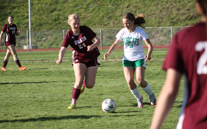 Anna Gray vies to get the ball as an opposing Bobcat player closes in, too.