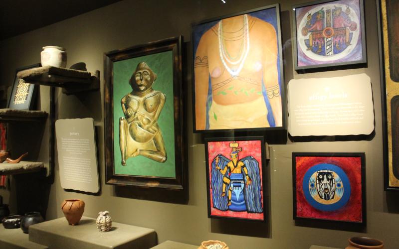 Some local artwork that now hangs at the Museum of the Cherokee People, replacing old exhibits in the museum’s ‘Disruption’ exhibit. “The sculptural figure with green background is by John Henry Gloyne (EBCI, Osage, Pawnee). The female torso to its right is by Isabella Saunooke (EBCI). The others are by Lou Montelongo (EBCI),” said Anna Chandler, Manager of External Affairs and Communications with the museum.