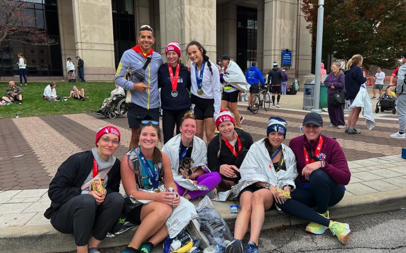 Kallup McCoy (2nd row left) is pictured with his team of athletes he coaches after the Indianapolis Marathon this past October, including his wife Katelynn Ledford-McCoy (1st row, 3rd from left).