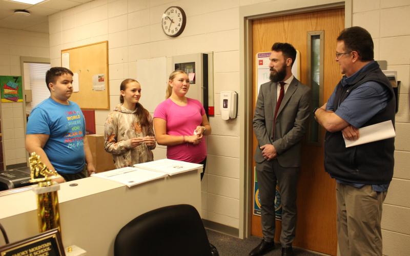 Swain County Middle School students Conner Bowman (from left), Cara Aldridge and Brylee Shuler greeted Sen. Kevin Corbin (far right) for a walkthrough of the middle school on Thursday, March 7. Middle school principal Ryan McMahan (middle) was glad to welcome the legislator.