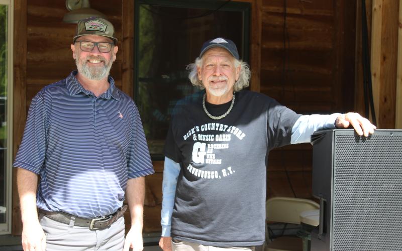 From left, Zach Thomason and Robin Fronrath work on Tuesday getting everything ready for the Sprang Thang musical festival to be held at Lands Creek Log Cabins Thursday-Saturday.