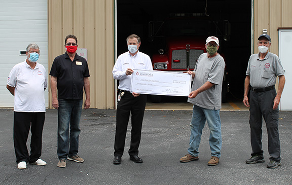 West Swain accepts the check