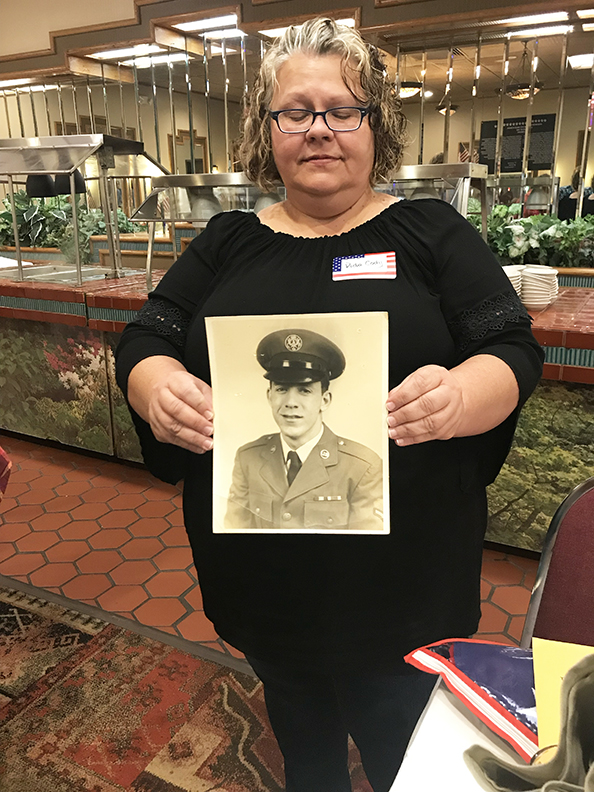 Vida Hall Cody holds a picture of her deceased father  Phillip Michael Hall from when he was in the Air Force.