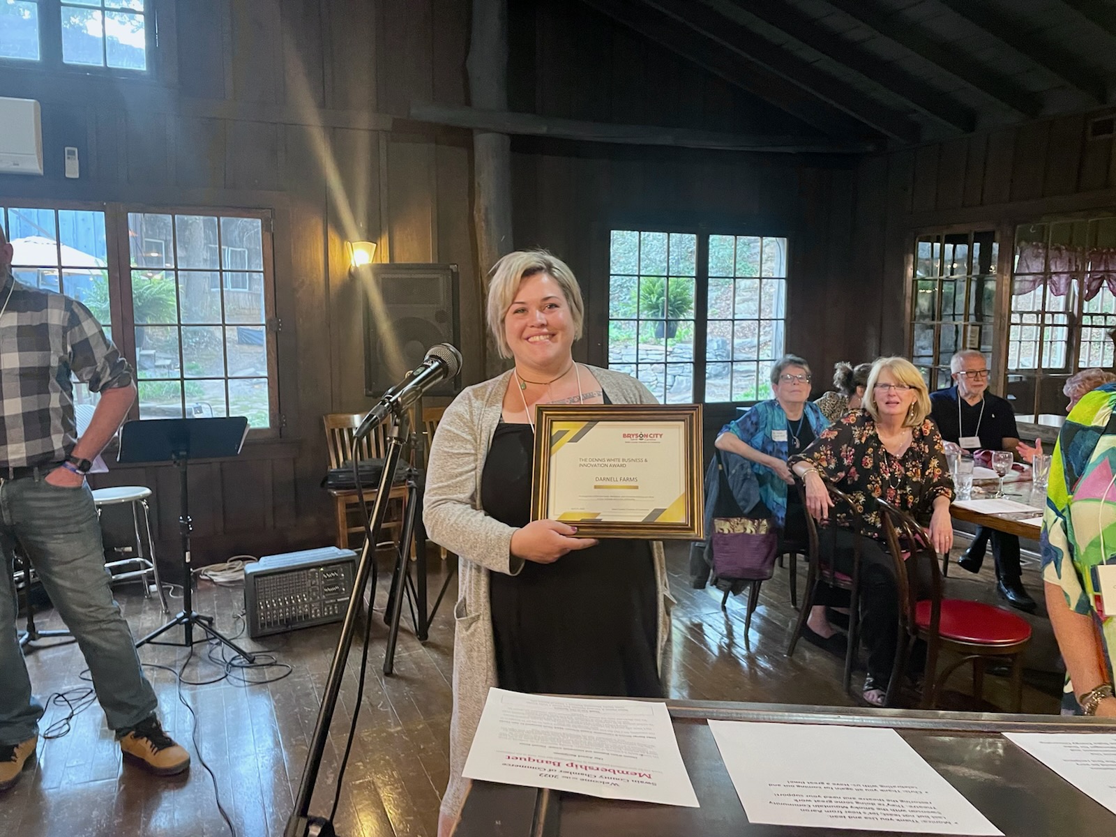 Afton Darnell Roberts accepts the Dennis White Business Citizen of the Year awarded to Darnell Farms
