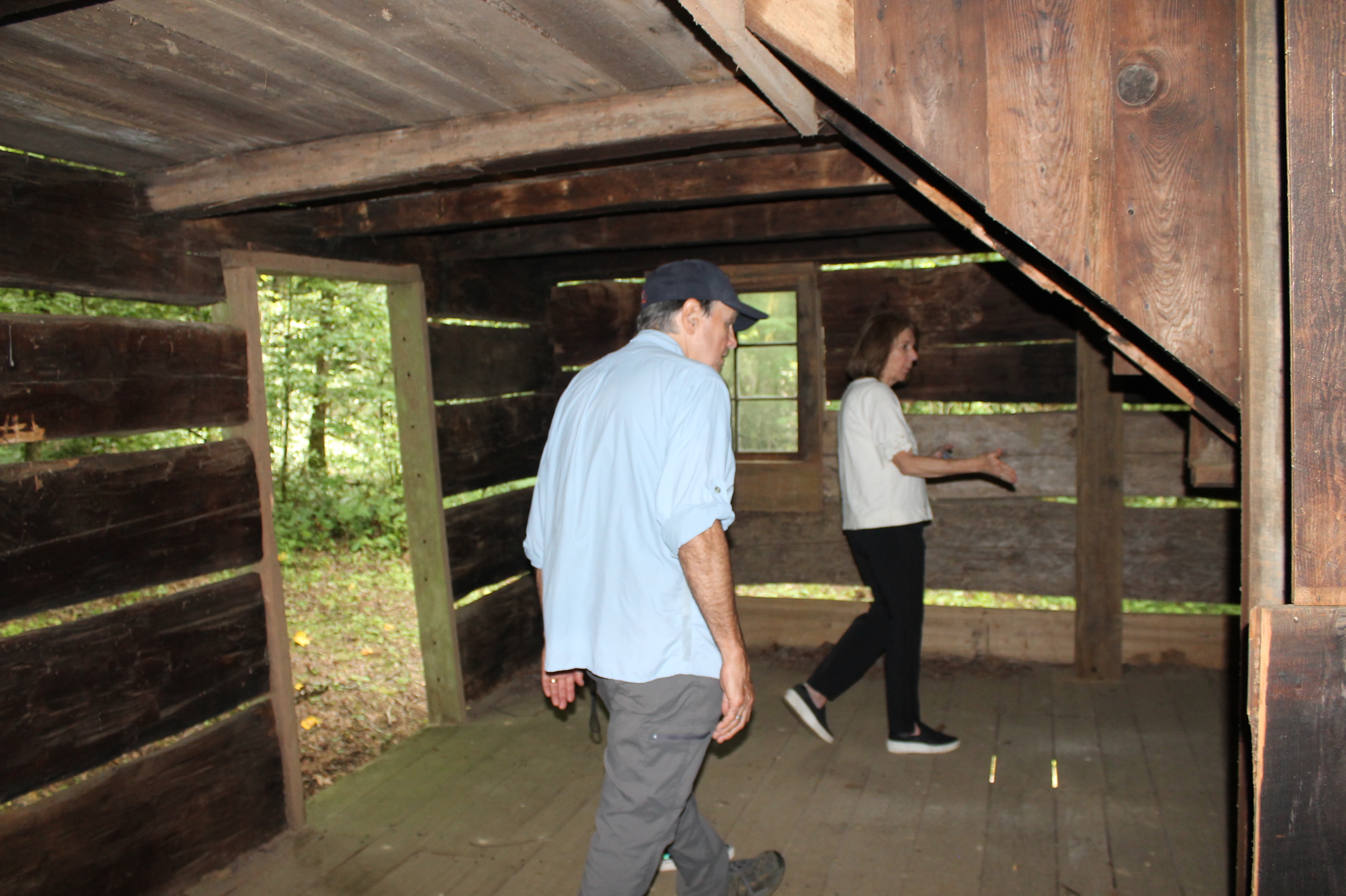 Some guests explore at the Hall Cabin observing the 150-year-old structure.