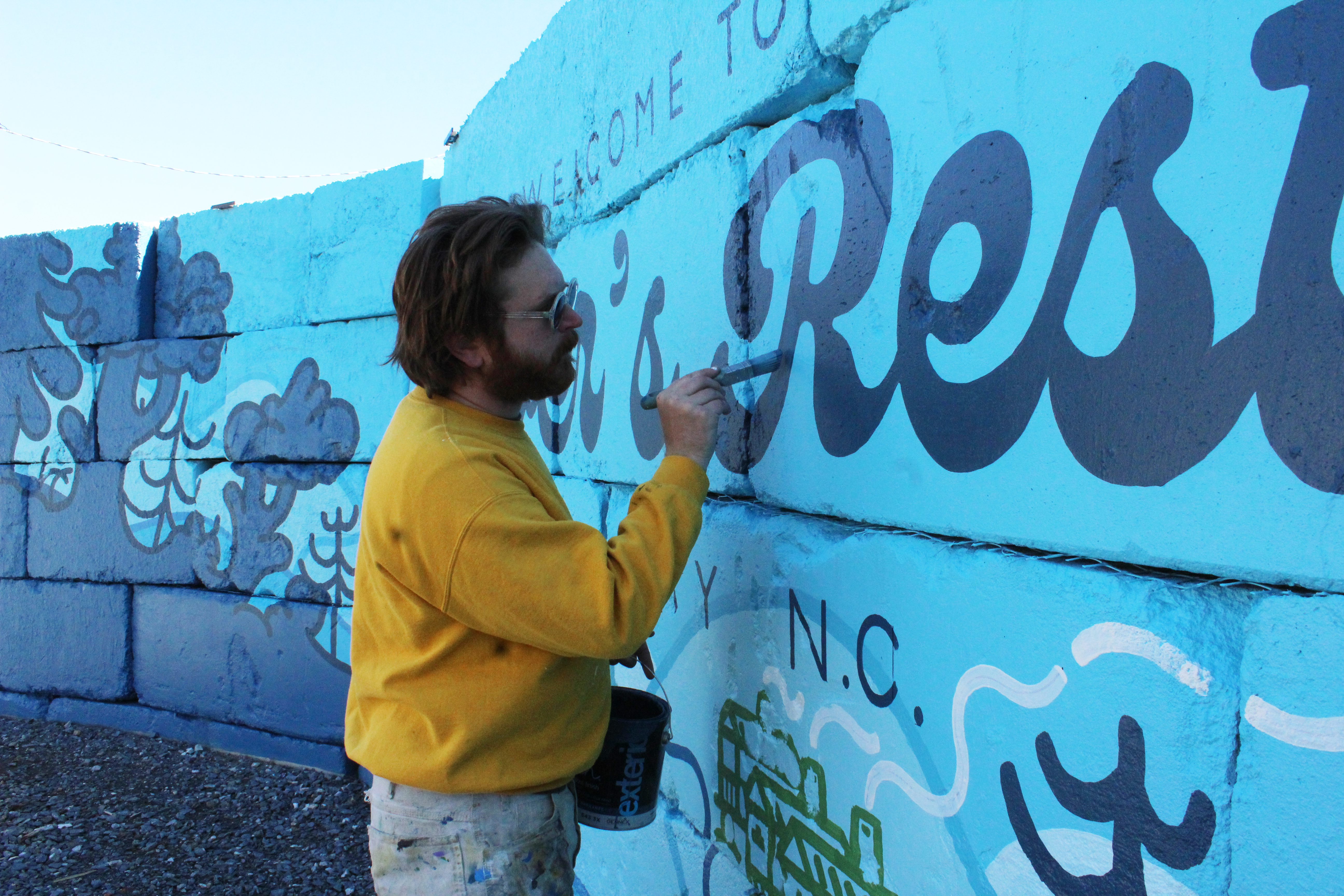 Brevard artist Eron Hare was contracted to paint a mural for the River’s Rest tiny home community, which will be open soon for vacation rentals on Hwy 19 South in Bryson City.
