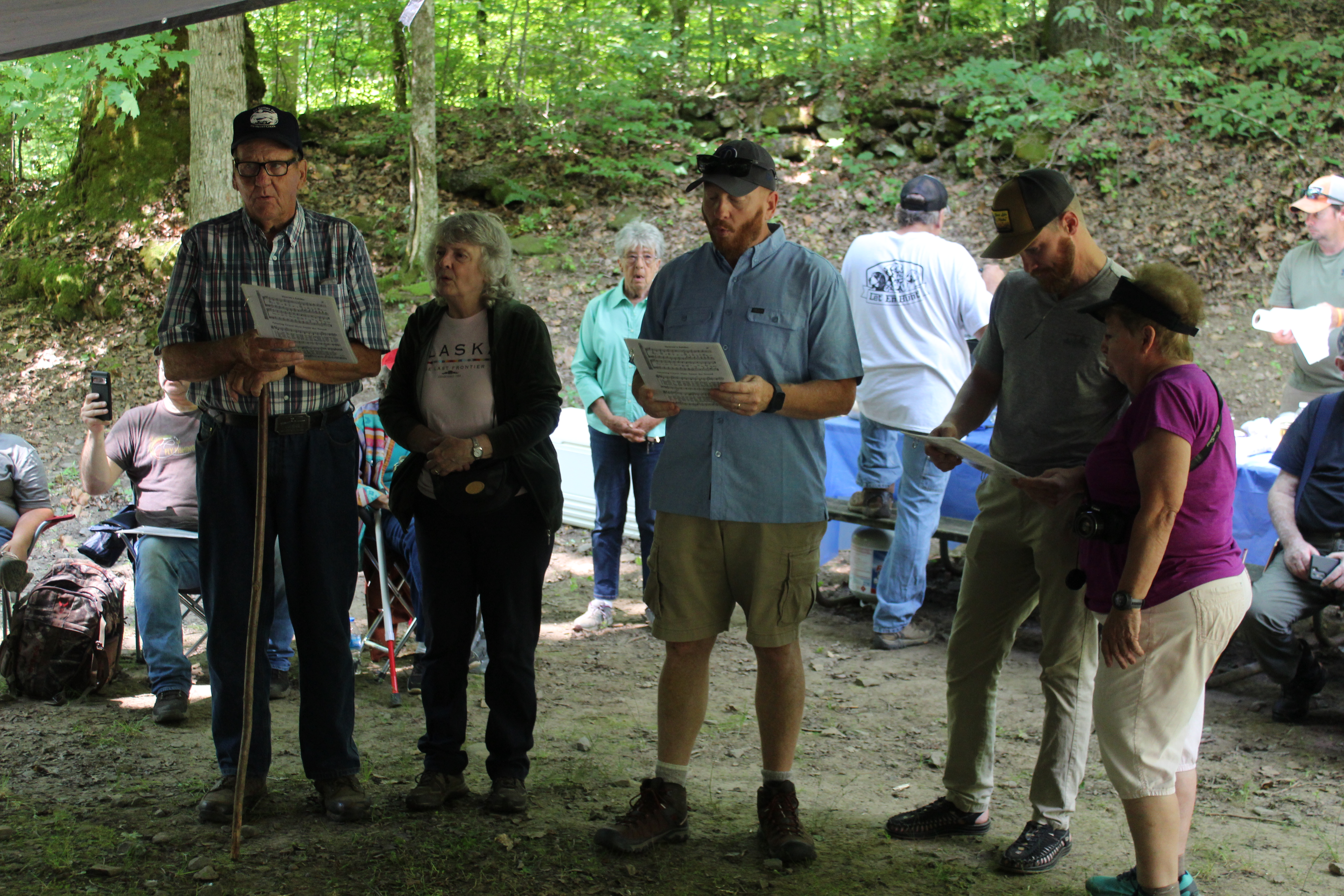 A group leads the singing of gospel songs before a service and the meal is served at the Bone Valley and Hall cemetery decoration day.