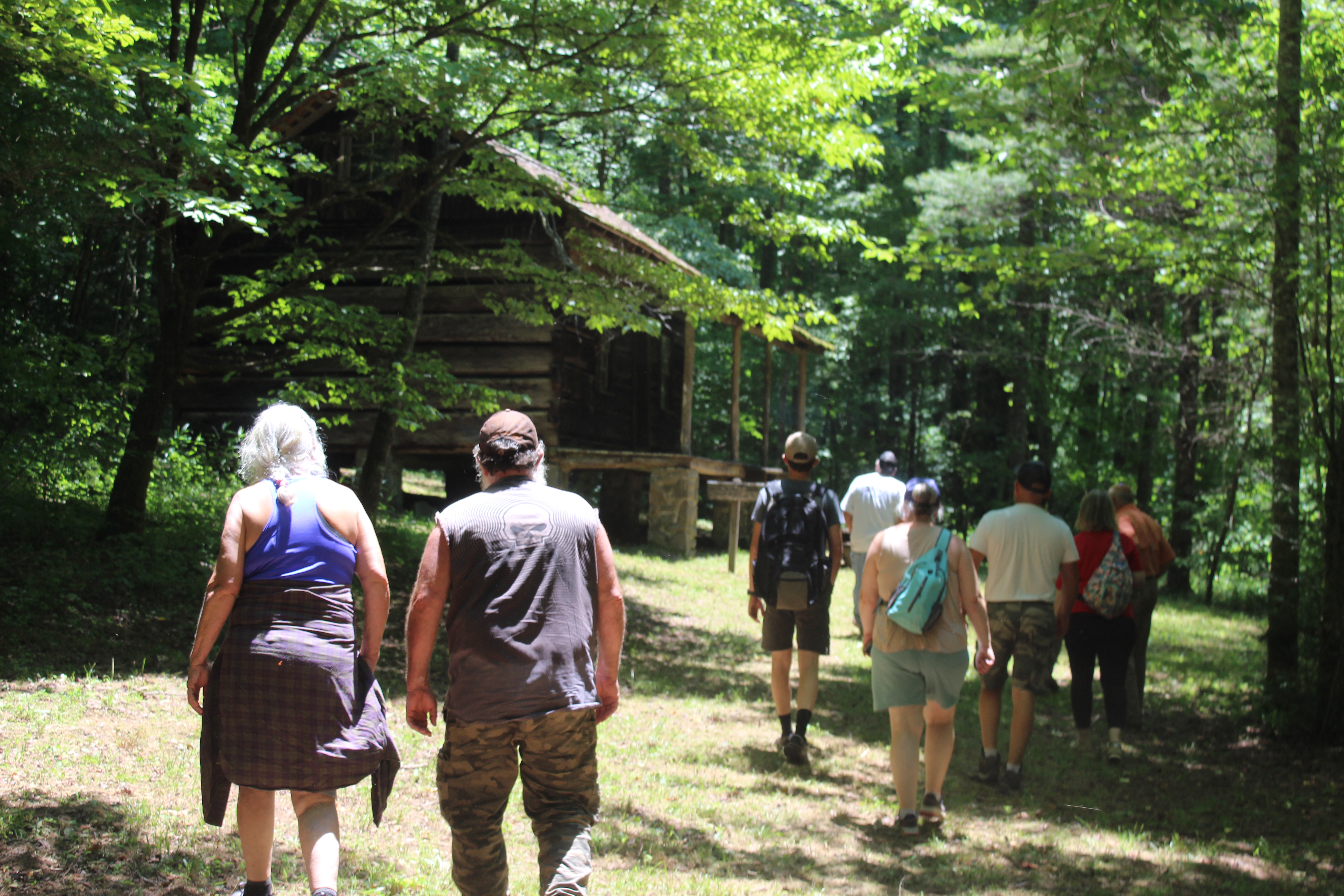 People walk up to see the Hall Cabin and learn about Kress Lodge that was located next to it before decorating Hall Cemetery. 