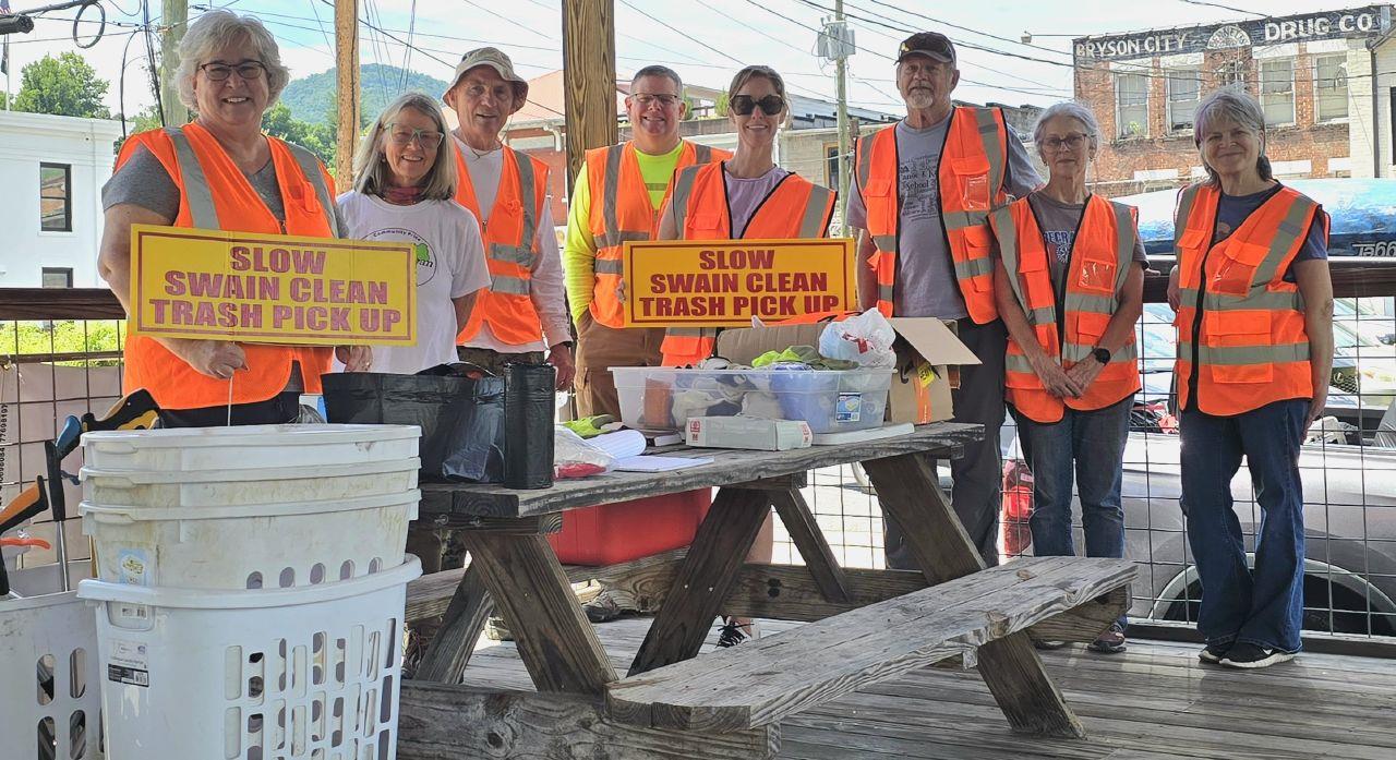 Swain Clean volunteers Cynthia Womble (left to right), MaryK Buranosky, Joe Buranosky, Thomas Womble, Stacy Miller, Ben Harrison, Jane Harrison and Valerie Ely gather at the riverside pavilion behind the Swain County Visitor Center and Heritage Museum June 20.