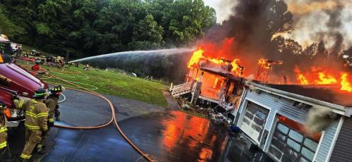 Firefighters participate in live-burn training off DeHart Cove Road June 23.