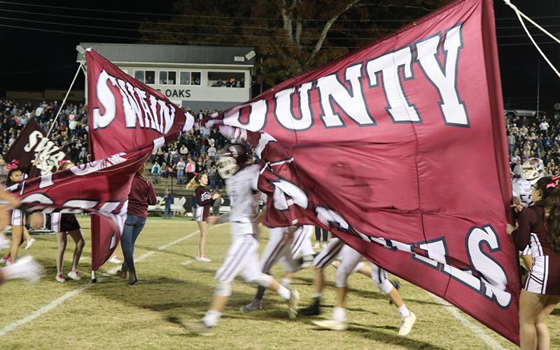Devils burst through their sign on the field