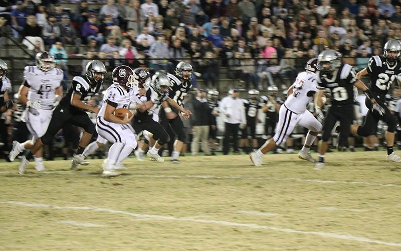 A Maroon Devil advances the ball