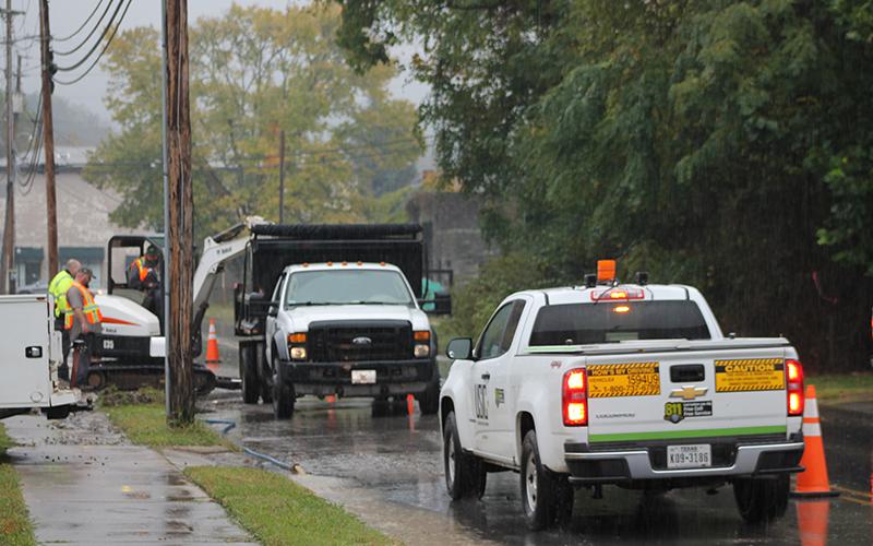 Workers try to fix the water line