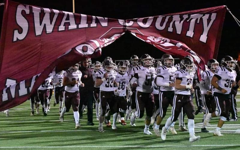 The Swain County Maroon Devils varsity football team takes the field against Hayesville.
