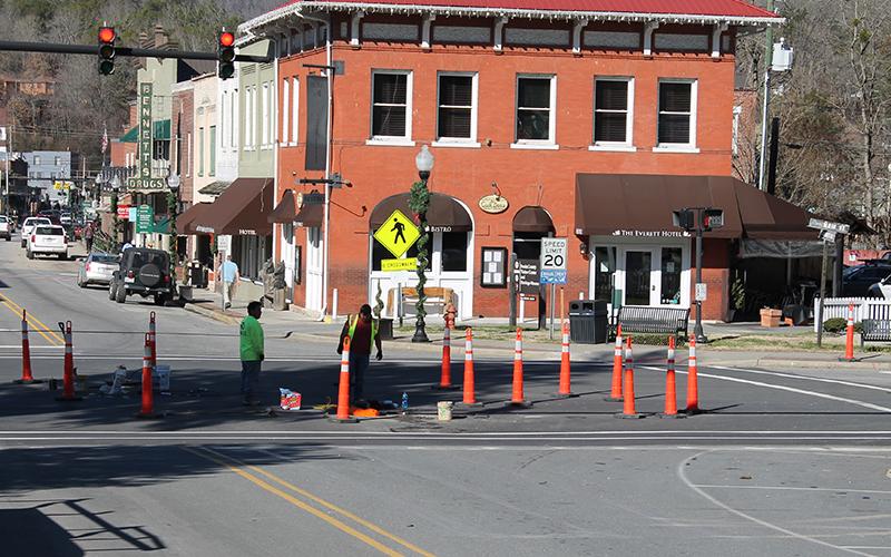 Contractors with Teraflex continue work on the water and sewer lines on Main Street with one man emerging from the manhole on the street.