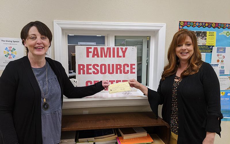 Karen Proctor of the Swain County Chamber of Commerce presents Family Resource Center Director Melissa Barker with a check for $150 for food purchases.