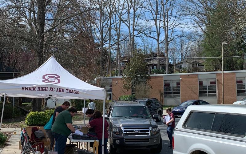 Staff hands out laptops at Swain Middle