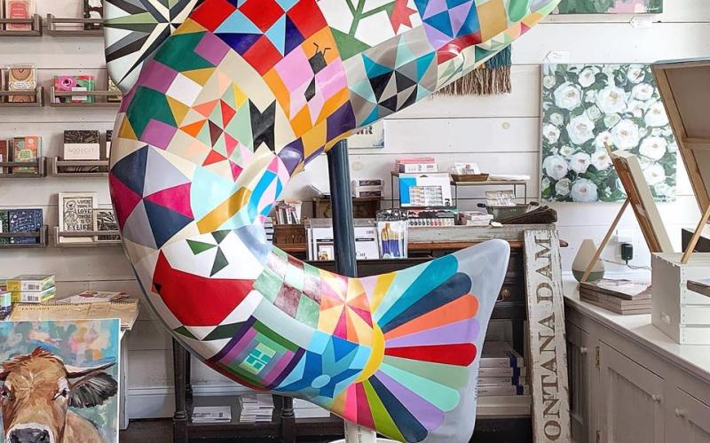 Ashley Hackshaw of Bryson City recently completed painting this trout statue with its detailed quilt pattern. The statue is one of the new statues paid for the TDA.