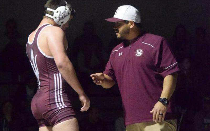 Adam Jaimez speaks to one of his wrestlers