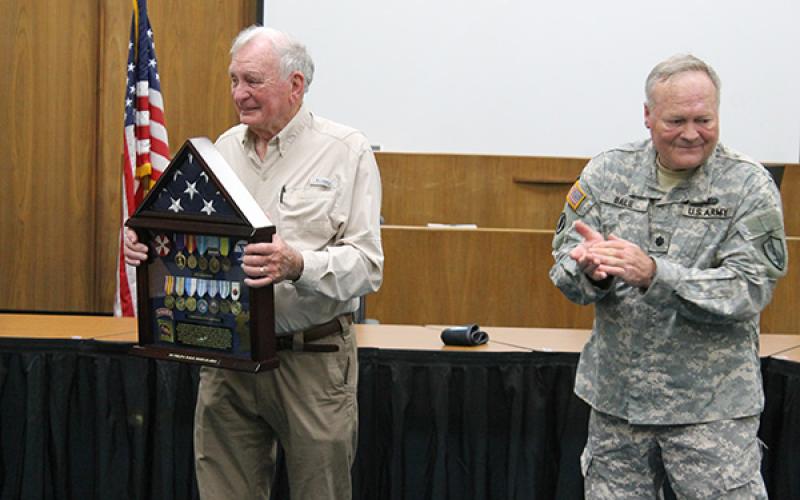 Philip Bailie accepts the shadow box from his son, Jim Bailie.