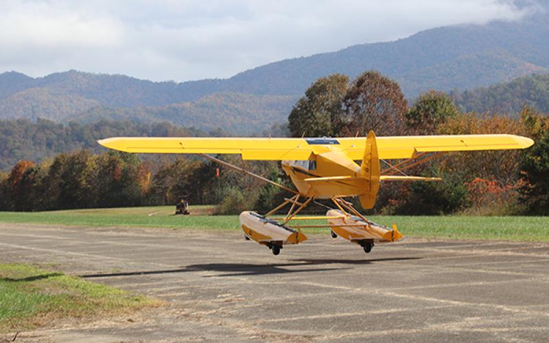A yellow plane lands