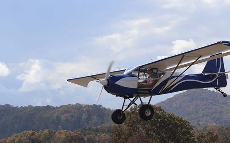 A blue plane lands