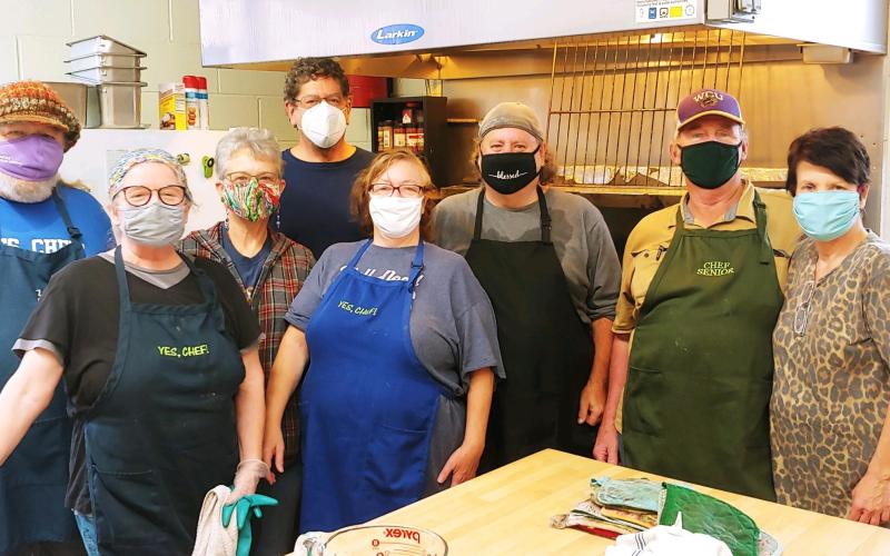 Giving Spoon cooks stop for a photo while preparing meals