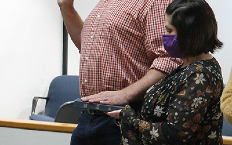 Kenneth Parton swears an oath for his next term of office as a Swain County Commissioner. He's pictured with his wife, Nicole Parton.