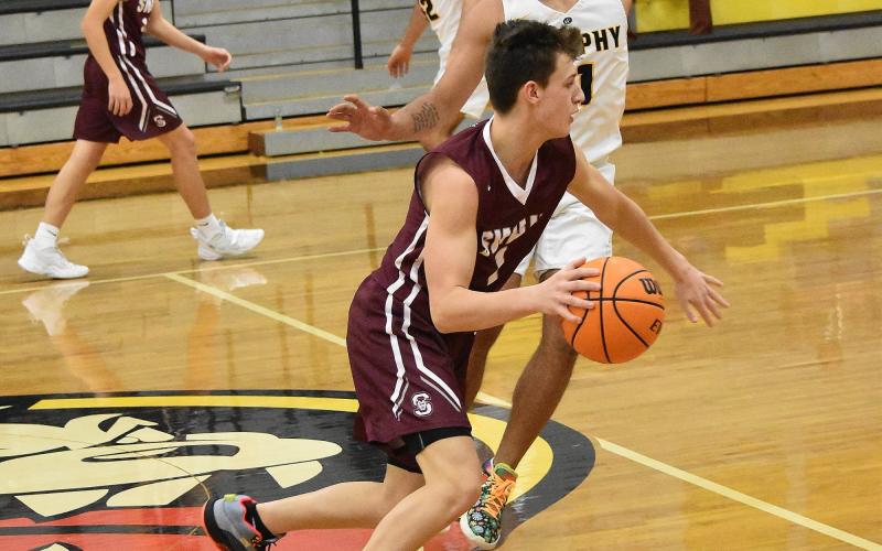 Maroon Devil Carter Kirkland, junior, advances the ball down the court in the Murphy away game that ended as a loss for the Devils despite the team scoring 79 points.
