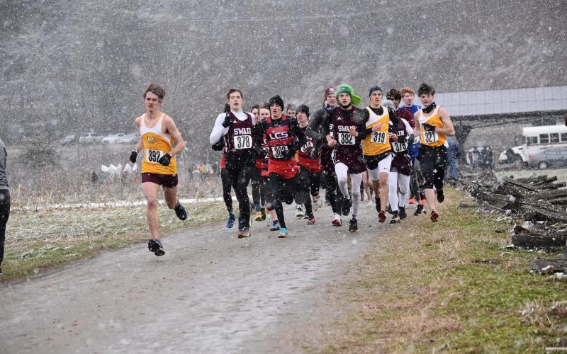 Swain County Maroon Devils cross country team is pictured with other competing teams at the regional match held Saturday at Kituwah Mound amid cold temperatures, wind and snow.