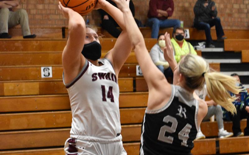 Photo by Kevin Hensley/Graham Star Lady Maroon Devil Savannah Smith fends off a Robbinsville Lady Knight and takes a shot.