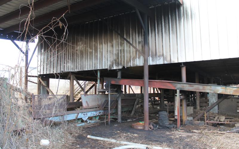 Smoke damage is visible on the metal siding of the building that was formerly operated as a lumber company. The cause is still under investigation, but arson is suspected.