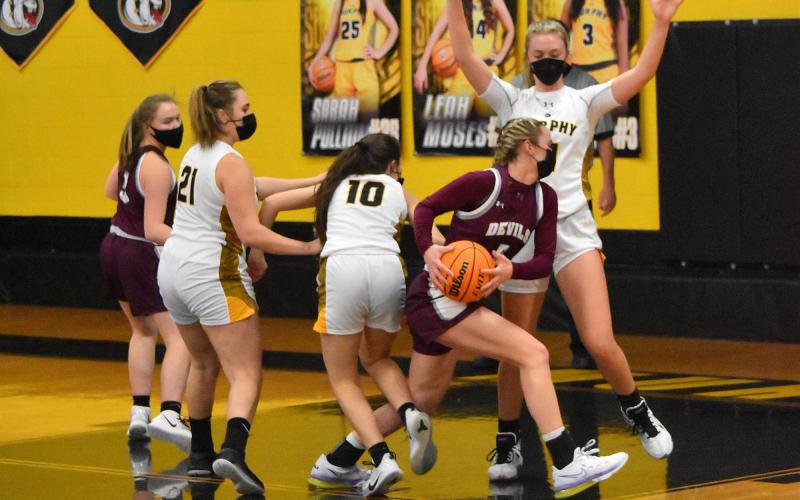Lady Devil Mazie Helpman, junior, drives the ball and shoots and scores in the away 68-51 loss against Murphy on Friday night.