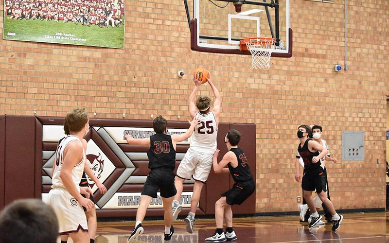Maroon Devil Isaiah Collins closes in on the basket in the home court 84-41 win against Rosman.