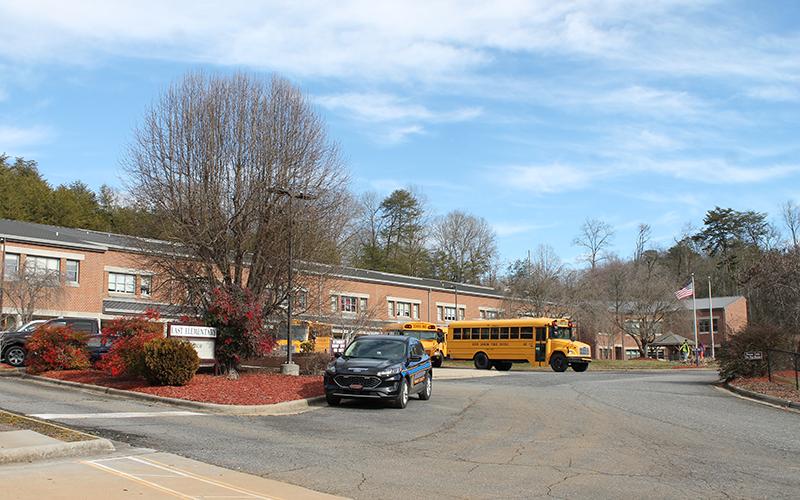 Buses are lined up outside East Elementary along with a Swain County SRO vehicle near the end of the school day on Monday. Elementary students in Swain County will be able to attend in-person four days a week beginning Monday, Feb. 22.