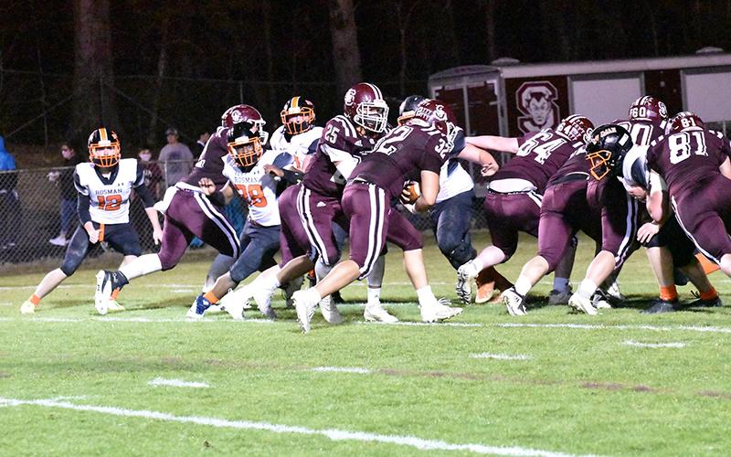Carson Taylor accepts a handoff from Damian Lossiah