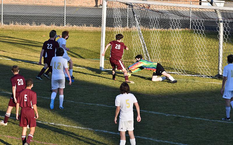 Photo by Chris Readman. Junior Lucas Trantham scores the final goal on the Hayesville Goalkeeper.