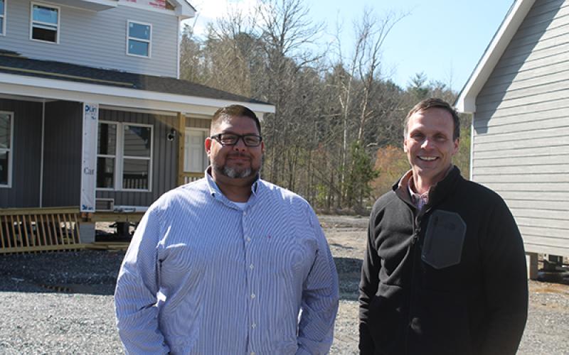 From left, Travis Smith,Kituwah Homes regional director of operations, and Jeremiah Wiggins, president, are pictured outside the eight model homes on the sales property that is located across the road from Food Lion in Cherokee. It’s slated to open in about a month.
