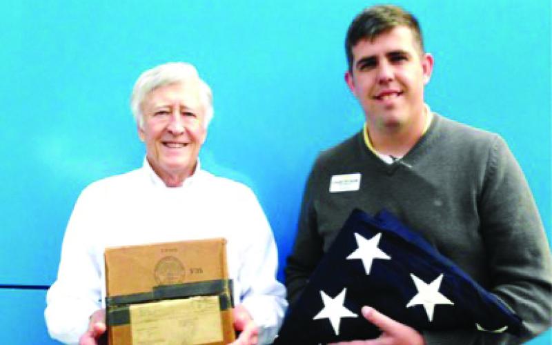 From left, David DeHart is holding the box that the flag was packed in and sent to the surviving spouse in May 1949 and Justin Kirkland holds a 48 Star American flag that he found and purchased at an Antique Auction House in Waynesville, several years ago.