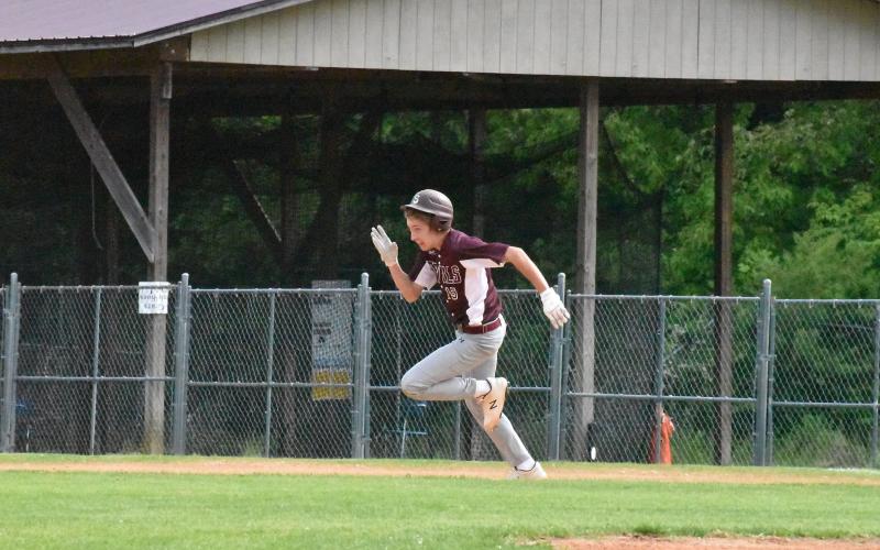 Photos by Joanna McMahan Maroon Devil Cooper Hyatt races to the next plate