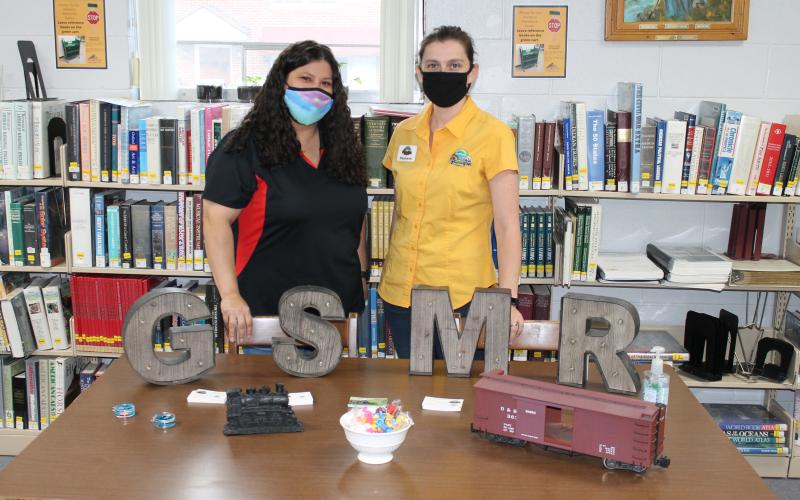 From left, Tasha Lee and Stephanie Rodeck represent Great Smoky Mountains Railroad at a hiring fair held at the Marianna Black Library last week.